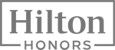 The image shows the Hilton Honors logo in grayscale, with "Hilton" in a box above "HONORS."